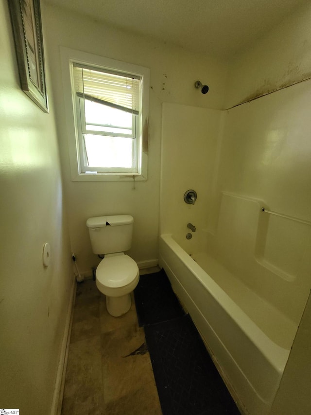 bathroom with toilet and bathing tub / shower combination