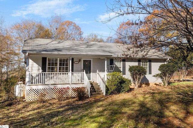 ranch-style house with covered porch and a front yard