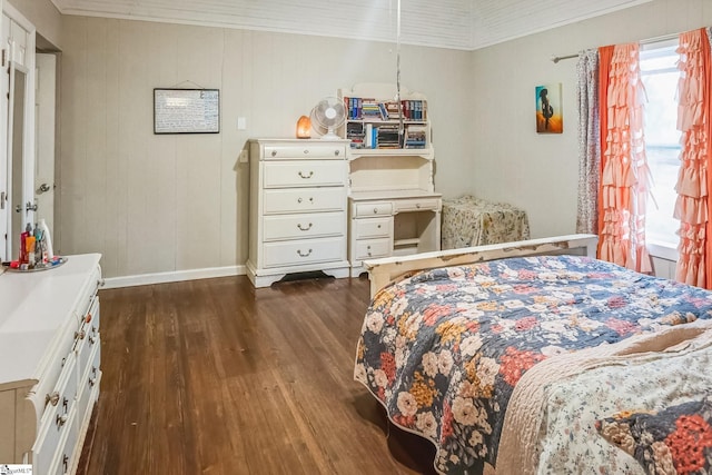 bedroom featuring ornamental molding and dark wood-type flooring