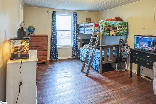 bedroom with dark wood-type flooring