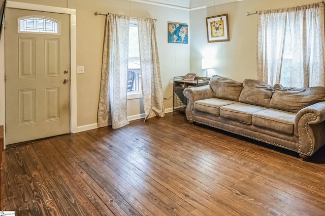 living room with dark hardwood / wood-style flooring and ornamental molding