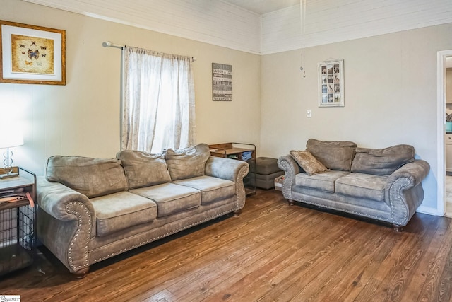 living room featuring hardwood / wood-style flooring and crown molding