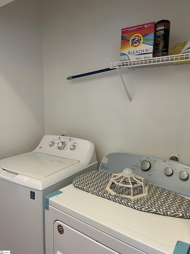 clothes washing area featuring washing machine and clothes dryer