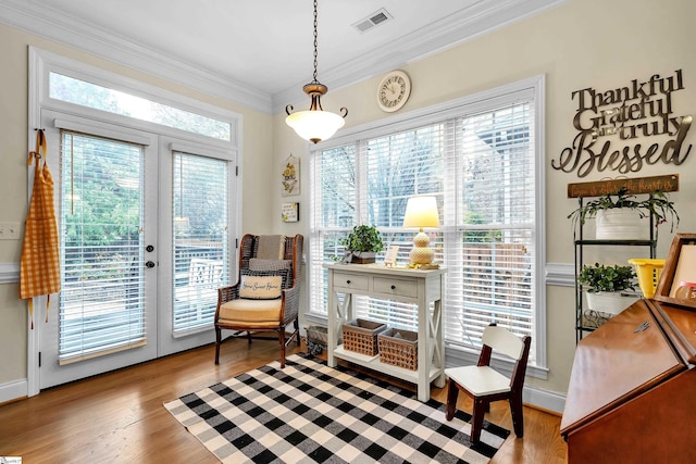 sitting room featuring light hardwood / wood-style floors, a wealth of natural light, and french doors