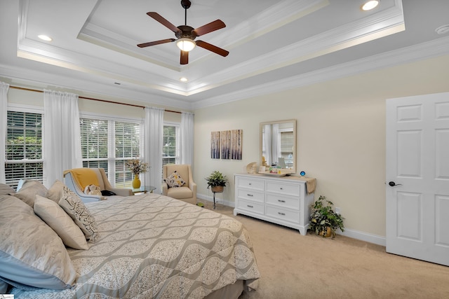 bedroom featuring a tray ceiling, ceiling fan, light colored carpet, and ornamental molding