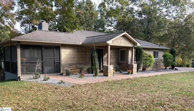 view of front of property with a front lawn and a sunroom