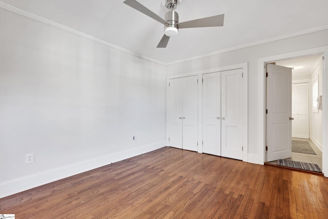 unfurnished bedroom with ceiling fan, wood-type flooring, and crown molding