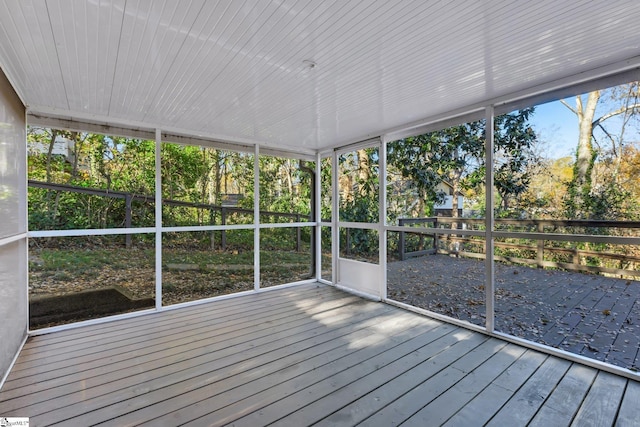 unfurnished sunroom featuring plenty of natural light and wood ceiling