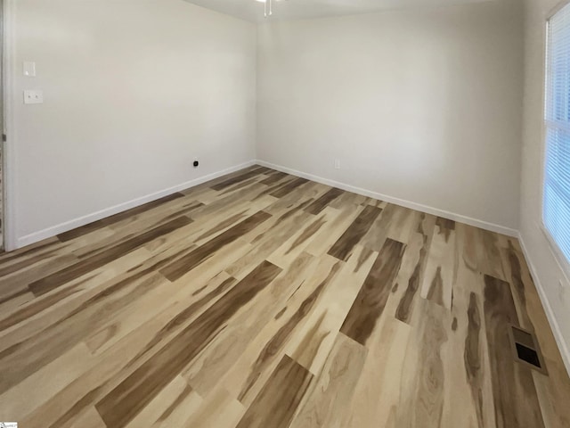 spare room with light hardwood / wood-style flooring