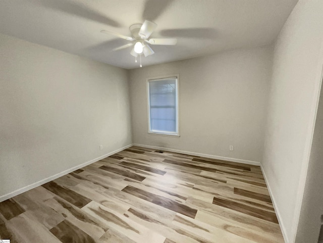 empty room with ceiling fan and light wood-type flooring