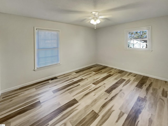 unfurnished room featuring light hardwood / wood-style floors and ceiling fan