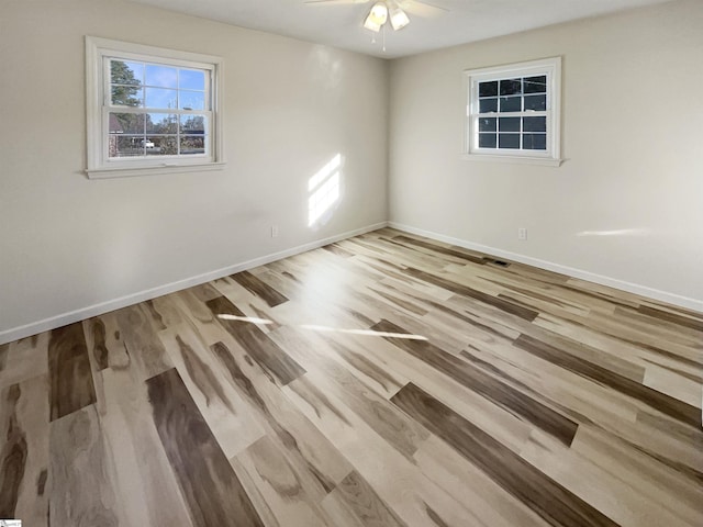 spare room featuring light hardwood / wood-style flooring and ceiling fan