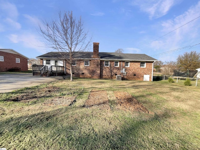 back of house featuring a yard, central AC unit, and a deck