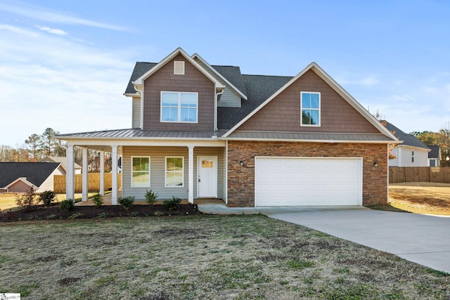 view of front facade with a front yard, a garage, and covered porch