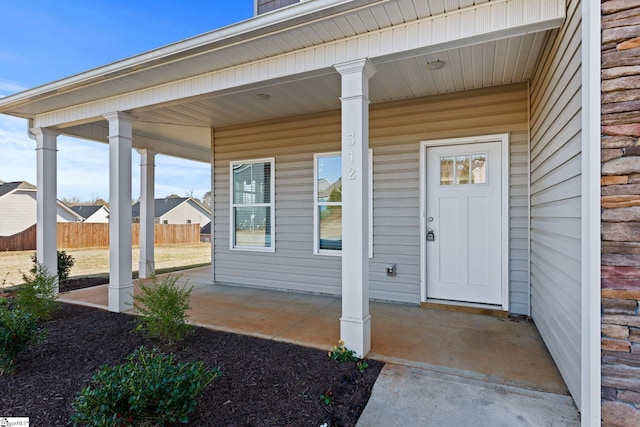 property entrance featuring a porch