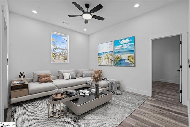 living room featuring ceiling fan and hardwood / wood-style flooring