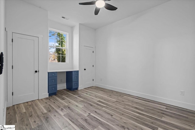 unfurnished bedroom with ceiling fan and light wood-type flooring