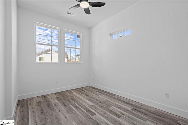 empty room with ceiling fan and light hardwood / wood-style flooring