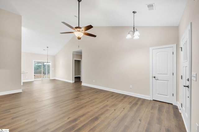 interior space with dark hardwood / wood-style floors, ceiling fan with notable chandelier, and high vaulted ceiling