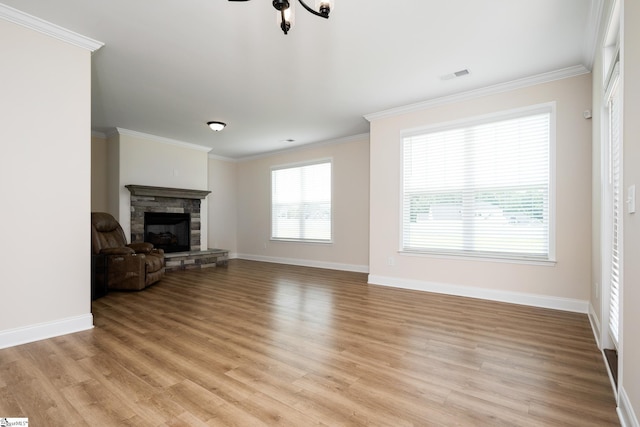 unfurnished living room with ceiling fan, light wood-type flooring, a fireplace, and ornamental molding