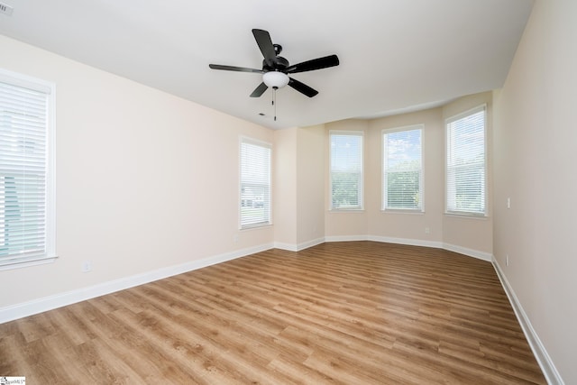 empty room featuring ceiling fan and light hardwood / wood-style flooring