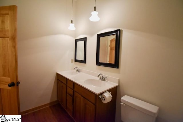 bathroom featuring hardwood / wood-style floors, vanity, and toilet