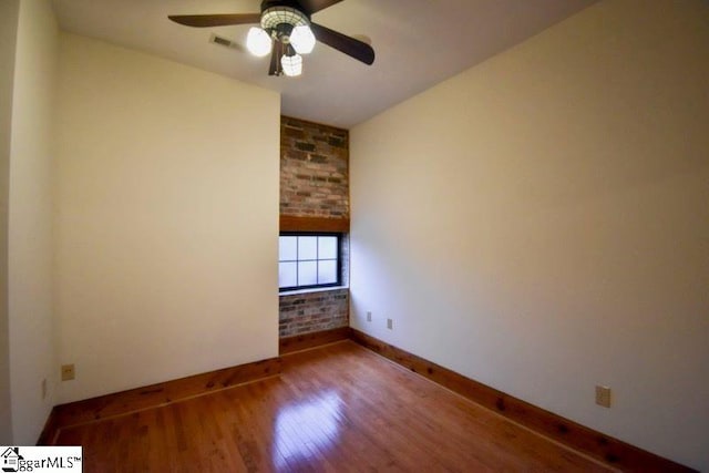 spare room with hardwood / wood-style floors and ceiling fan