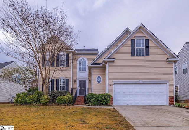 front of property featuring a garage and a front yard