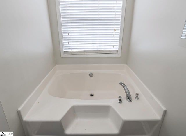 bathroom with a tub to relax in