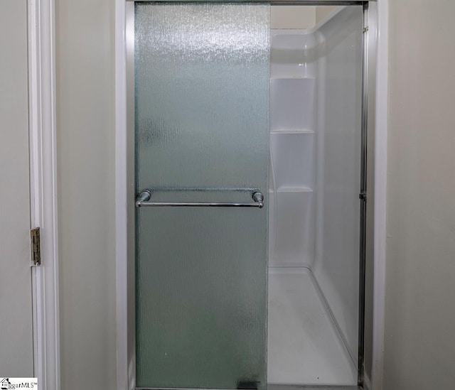 bathroom with a shower with shower door