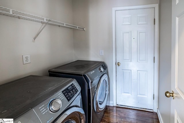 laundry area featuring dark hardwood / wood-style flooring and washer and clothes dryer