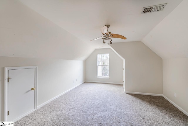 bonus room with ceiling fan, light carpet, and vaulted ceiling