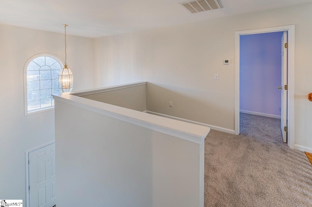 hallway with light colored carpet