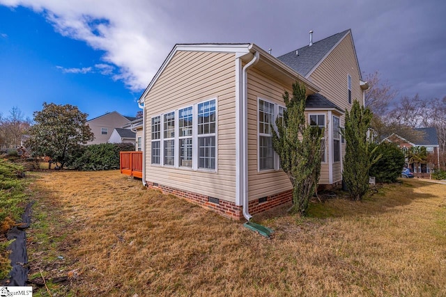 view of side of property with a yard