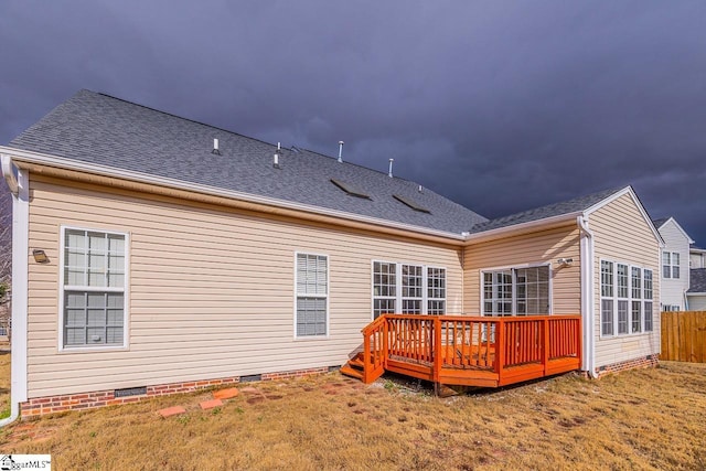 back of property featuring a lawn and a wooden deck