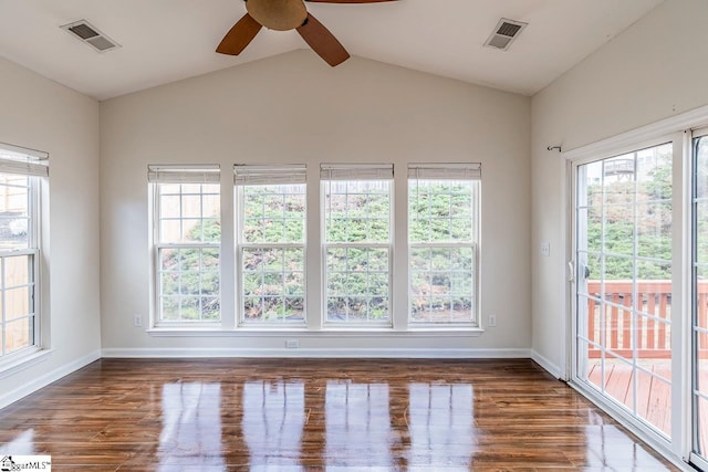 unfurnished sunroom featuring vaulted ceiling with beams, ceiling fan, and a healthy amount of sunlight