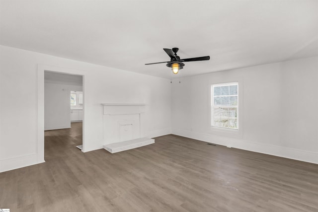 empty room with dark hardwood / wood-style floors and ceiling fan