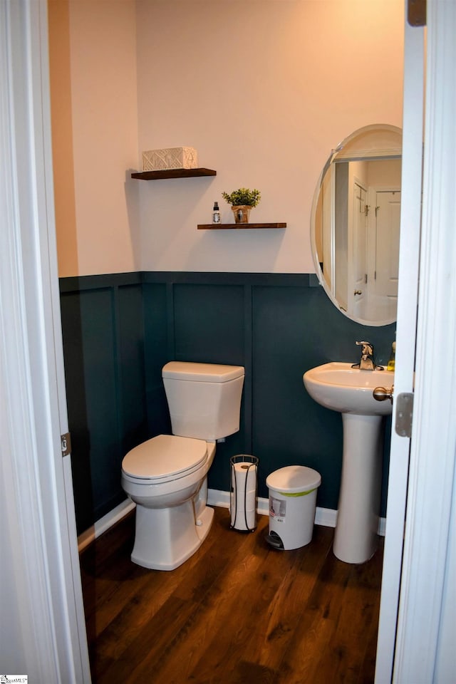 bathroom with sink, toilet, and hardwood / wood-style flooring