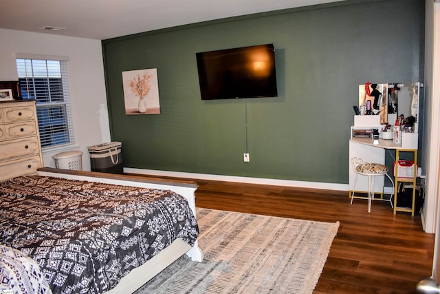 bedroom with dark hardwood / wood-style flooring