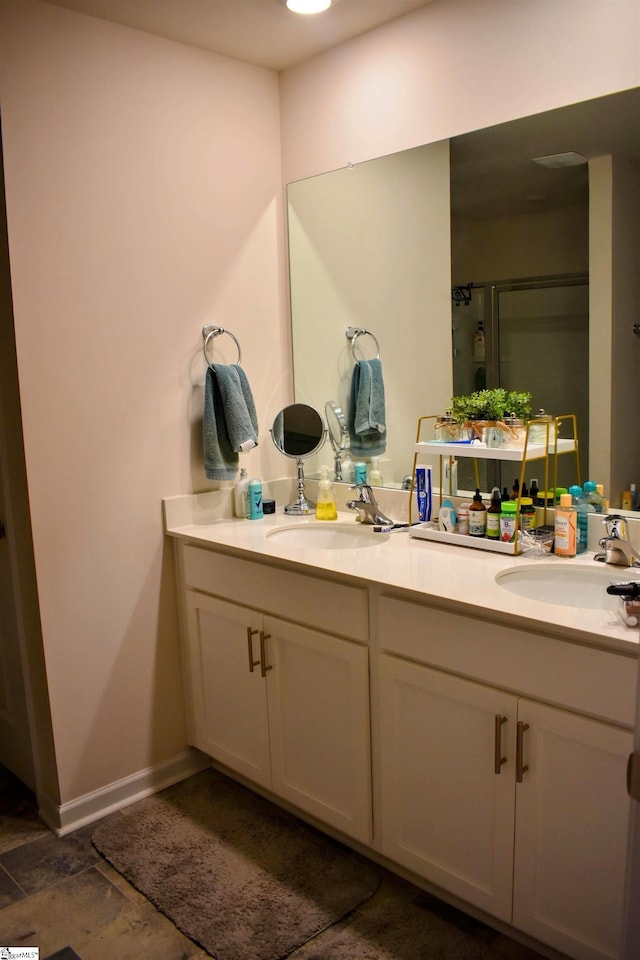 bathroom featuring vanity and an enclosed shower