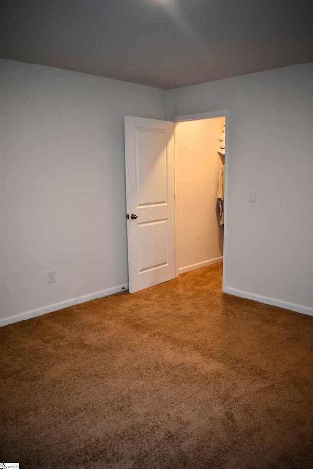 unfurnished room featuring carpet