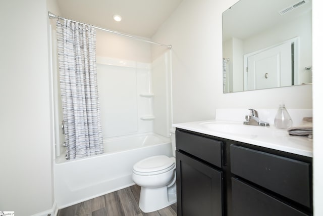 full bathroom with hardwood / wood-style flooring, vanity, toilet, and shower / bath combo