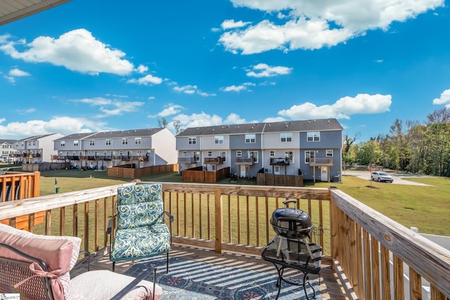 wooden deck featuring a yard