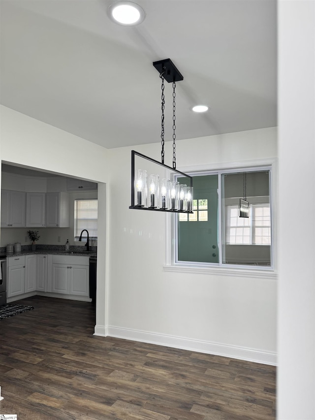 unfurnished dining area with sink and dark hardwood / wood-style flooring