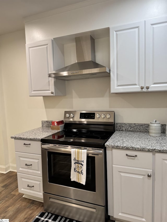 kitchen featuring white cabinetry, electric range, dark hardwood / wood-style floors, and wall chimney range hood