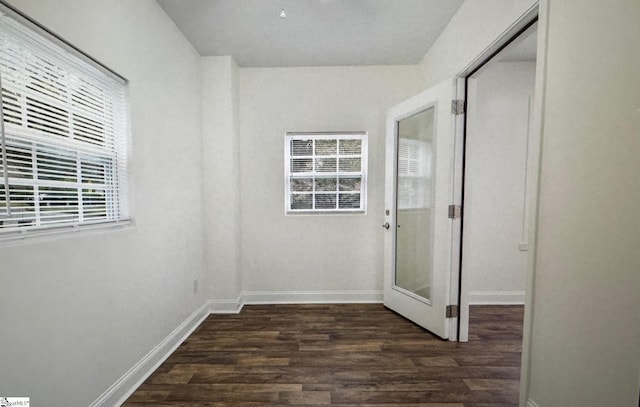 corridor with dark hardwood / wood-style flooring