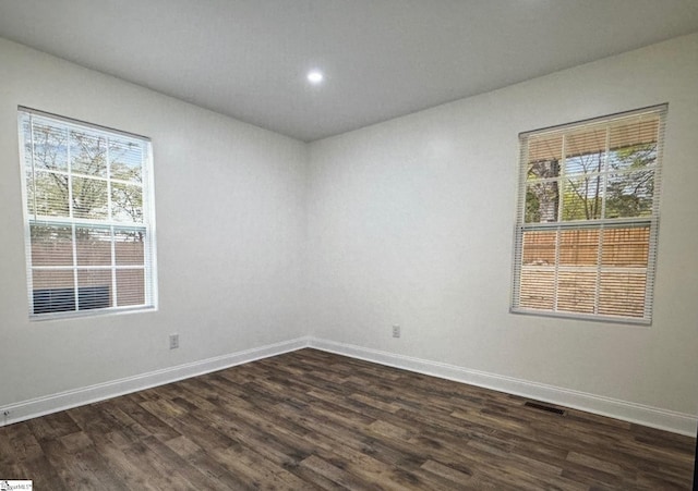 empty room with dark wood-type flooring