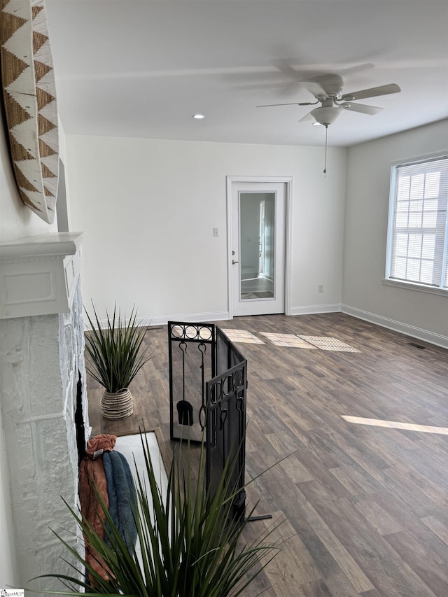 interior space featuring wood-type flooring and ceiling fan