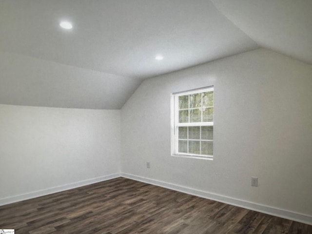 additional living space with lofted ceiling and dark hardwood / wood-style floors