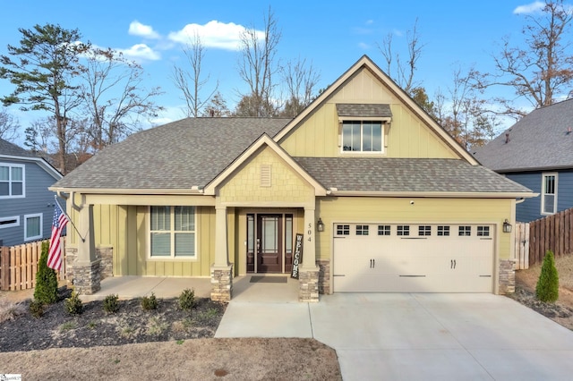 craftsman inspired home featuring covered porch and a garage